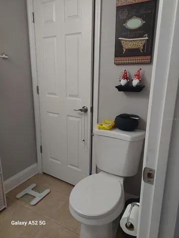 a white toilet sitting next to a bathroom sink and vanity