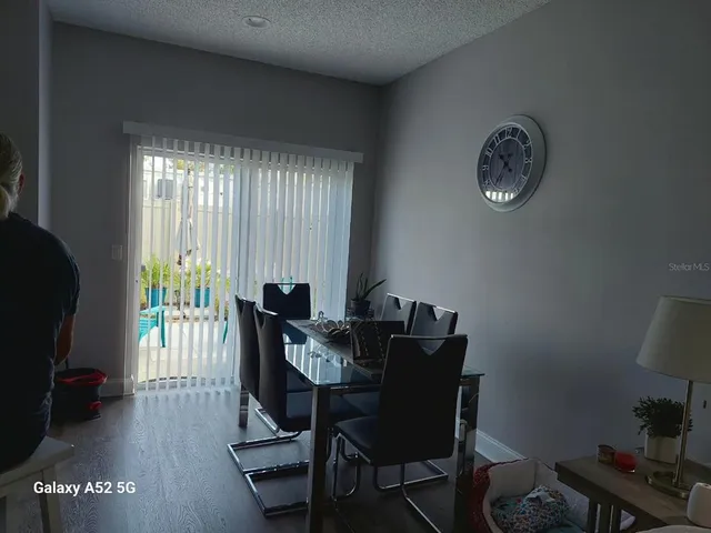 a view of a dining room with furniture and a window