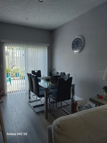 a living room with furniture a large window and a table