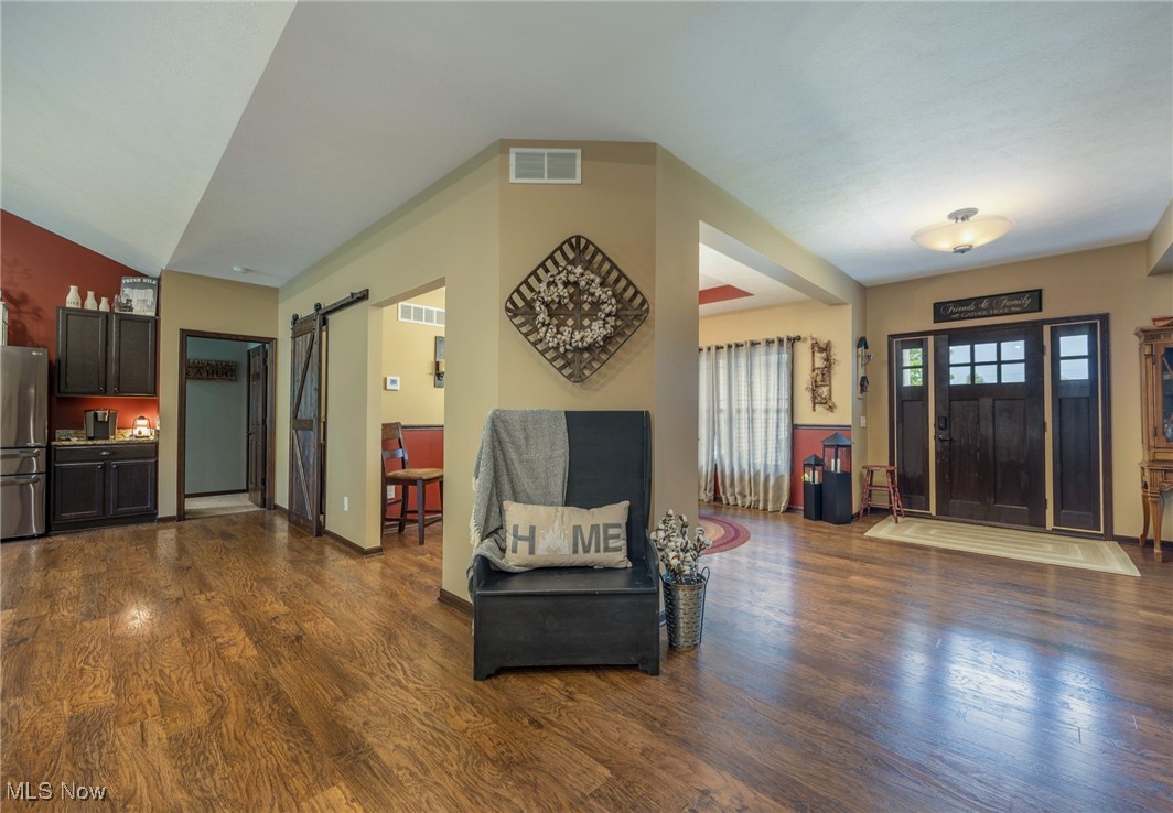 2851 Barnett Ridge Road Fleming, OH 45729 - Photo 20 of 40 Foyer with a barn door and dark wood-style flooring
