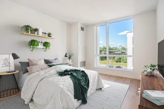 a bedroom with a bed and a window