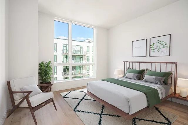 a bedroom with a bed and a window