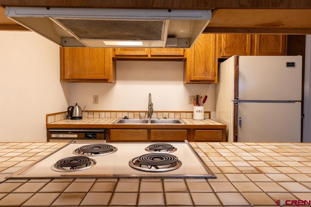 1851 Florida Road, Unit 106 Durango, CO 81301 - Photo 11 of 25 a kitchen with a stove and a refrigerator