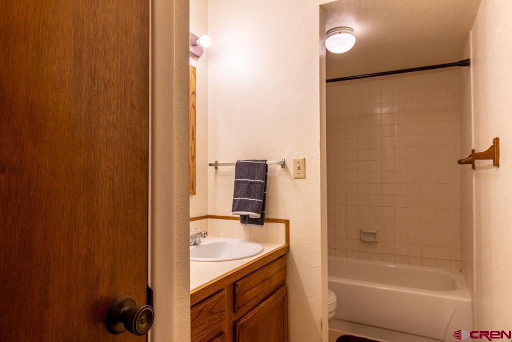 1851 Florida Road, Unit 106 Durango, CO 81301 - Photo 15 of 25 a bathroom with a granite countertop sink and a mirror