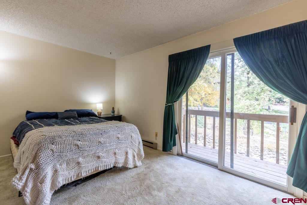 1851 Florida Road, Unit 106 Durango, CO 81301 - Photo 18 of 25 a bedroom with a bed and a large window