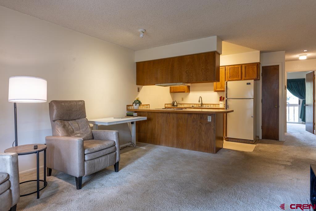 1851 Florida Road, Unit 106 Durango, CO 81301 - Photo 5 of 25 a kitchen with stainless steel appliances kitchen island granite countertop a refrigerator and a stove