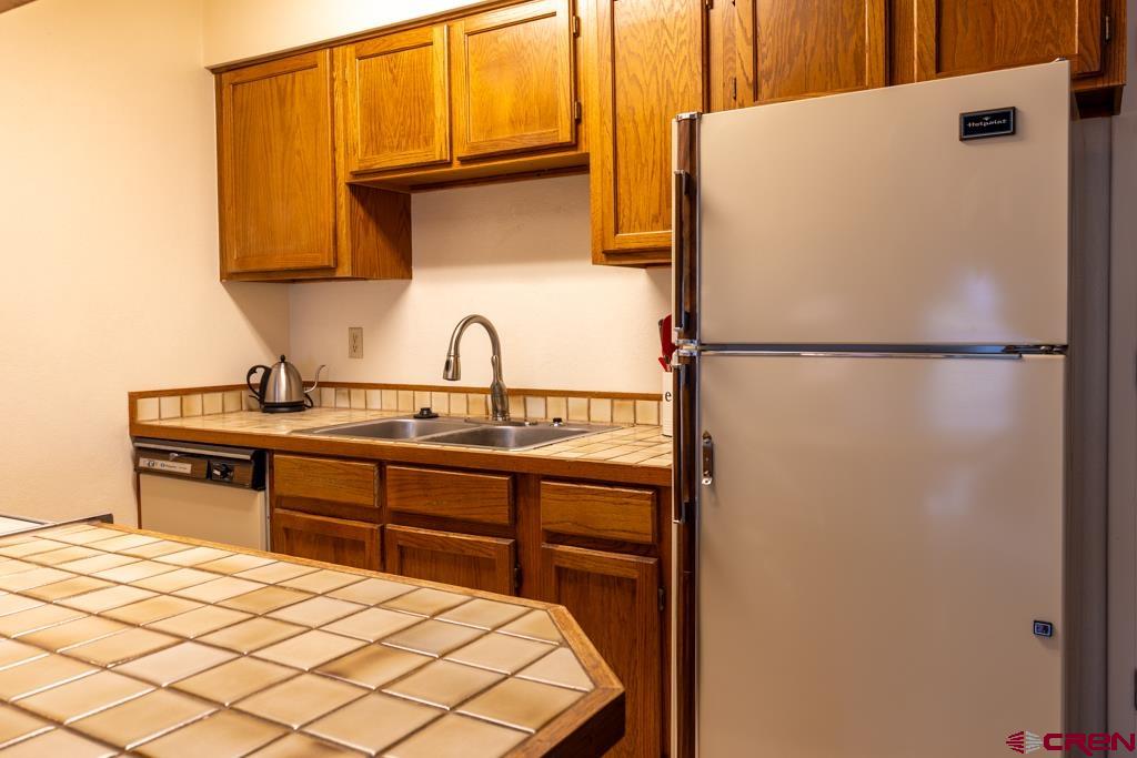 1851 Florida Road, Unit 106 Durango, CO 81301 - Photo 10 of 25 a kitchen with a refrigerator and a sink