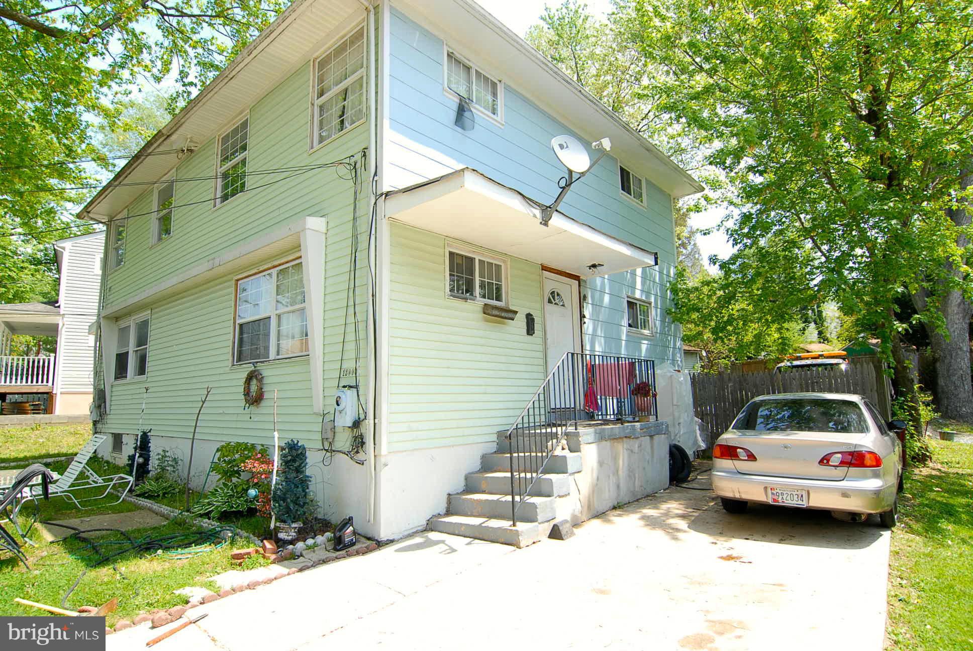 12009 Centerhill Street Silver Spring, MD 20902 - Photo 2 of 9 a car parked in front of a house