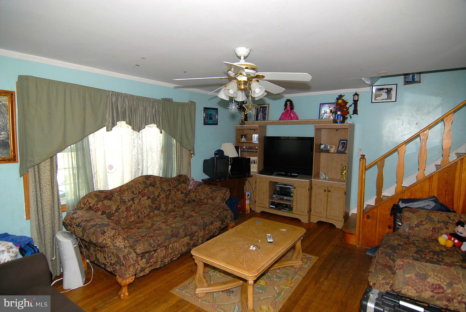 12009 Centerhill Street Silver Spring, MD 20902 - Photo 3 of 9 a living room with furniture and a flat screen tv