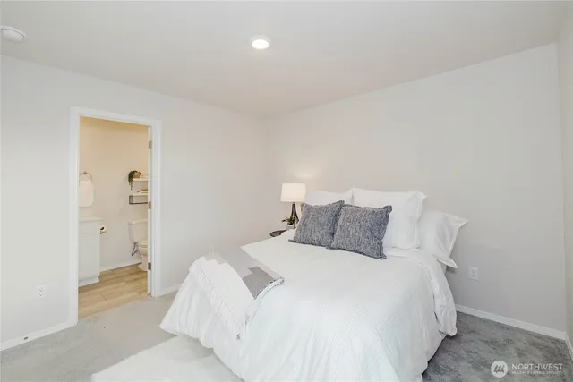 a bedroom with a bed and a view of bathroom