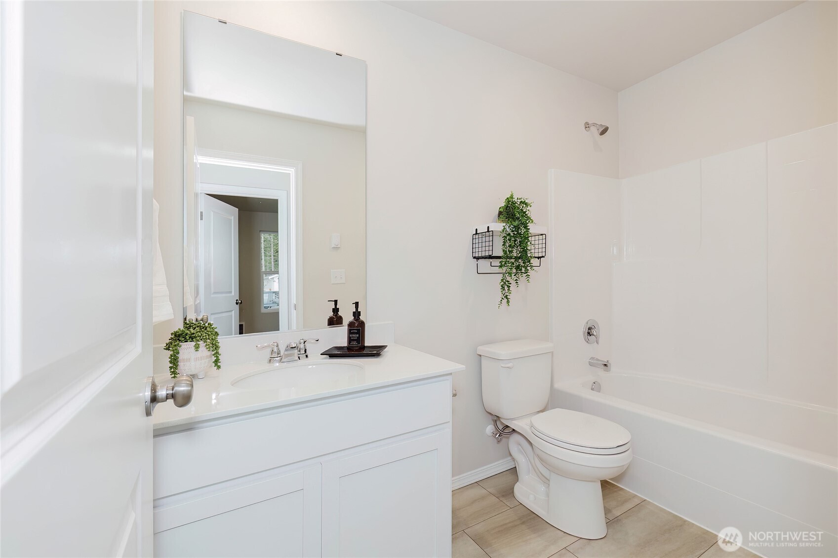 240 Northeast Olympic Ridge Belfair, WA 98528 - Photo 26 of 28 a bathroom with a toilet a sink and mirror
