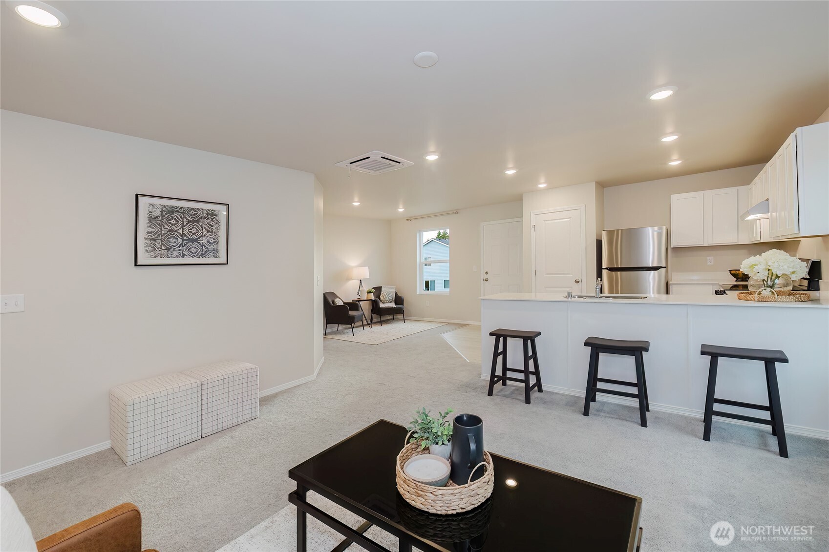 240 Northeast Olympic Ridge Belfair, WA 98528 - Photo 9 of 28 a living room with furniture and a dining table with kitchen view