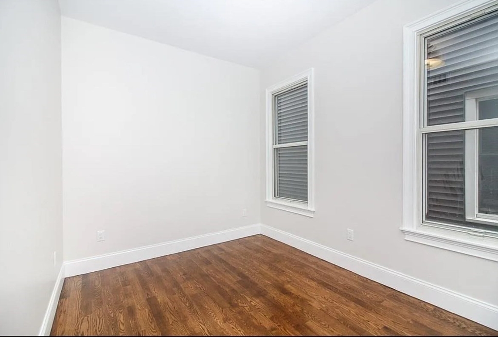 249 Lexington Street, Unit 2 Boston, MA 02128 - Photo 2 of 19 a view of an empty room with wooden floor and a window