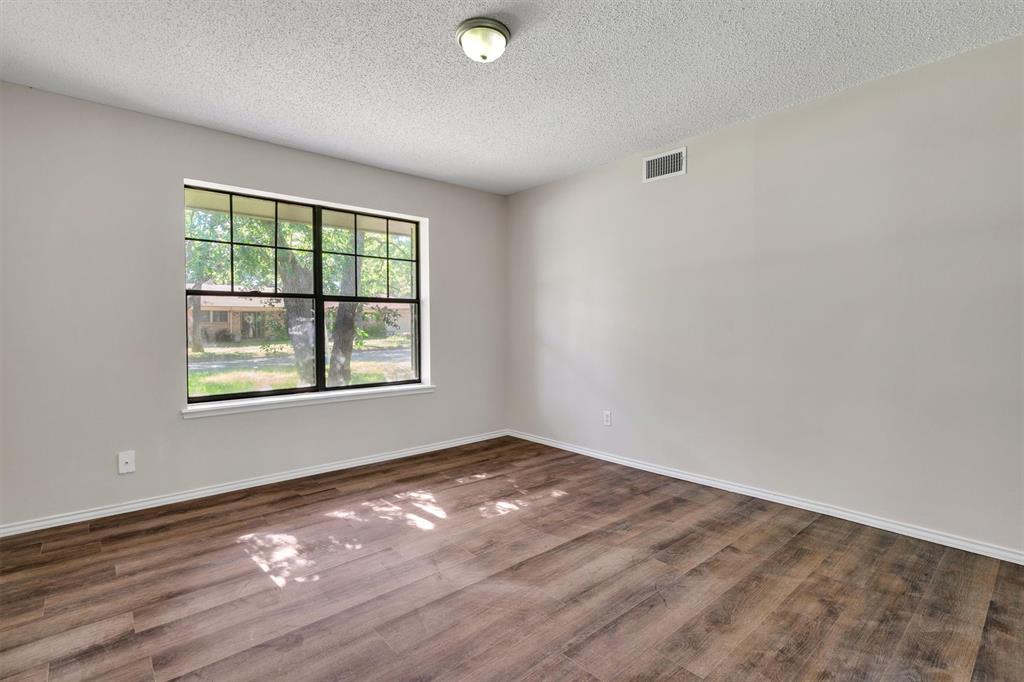 209 Mistletoe Lane Keene, TX 76059 - Photo 6 of 38 wooden floor in an empty room with a window