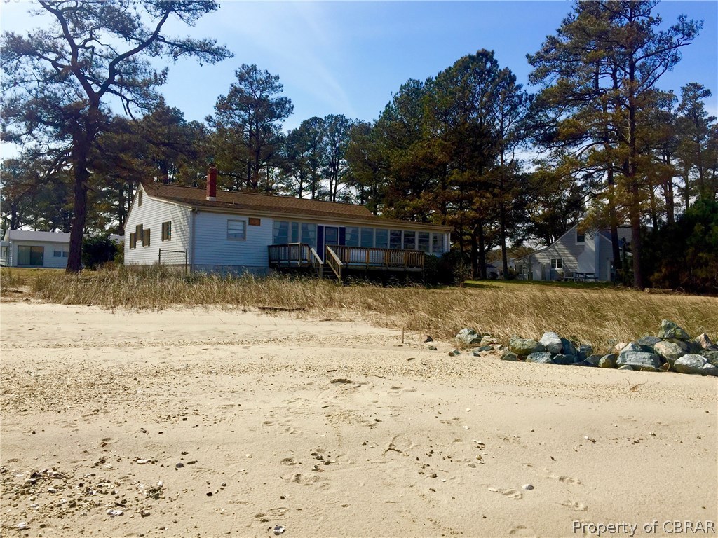 138 Montgomery Cove Road Deltaville, VA 23043 - Photo 1 of 11 View of the home from the sandy shoreline