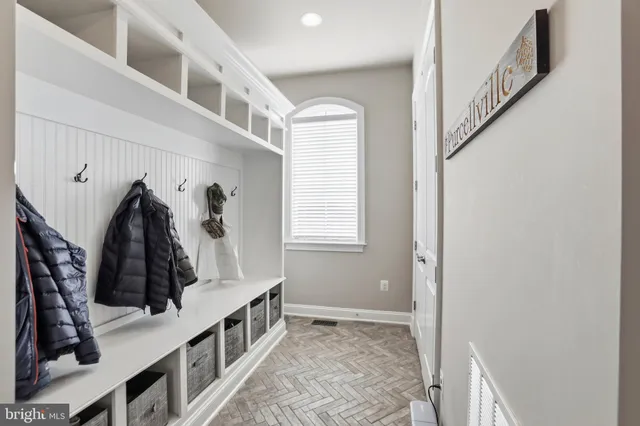 a bathroom with a sink a potted plant and a mirror