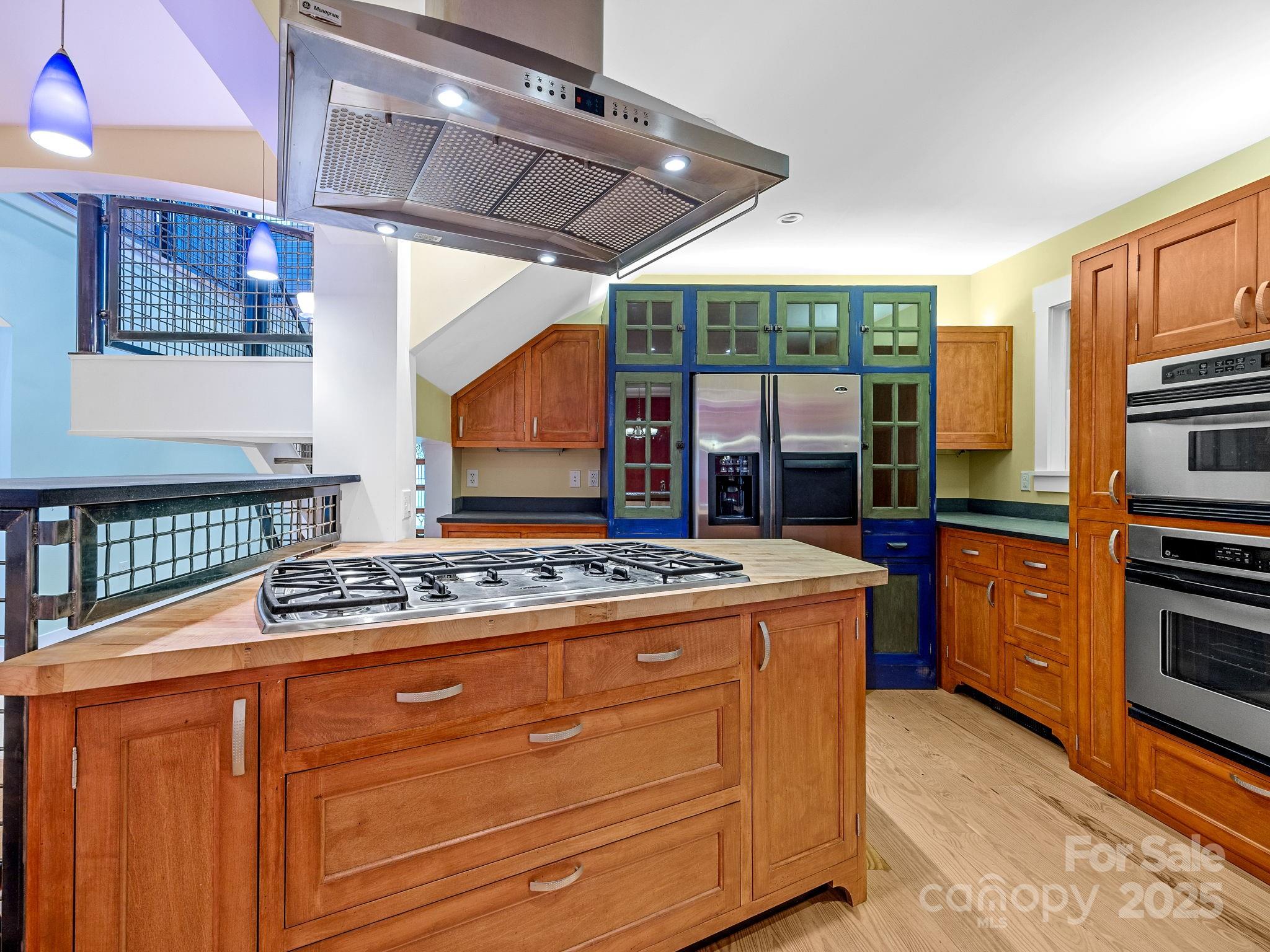 147 Woodland Road Tryon, NC 28782 - Photo 15 of 48 a kitchen with stainless steel appliances granite countertop a stove and a refrigerator
