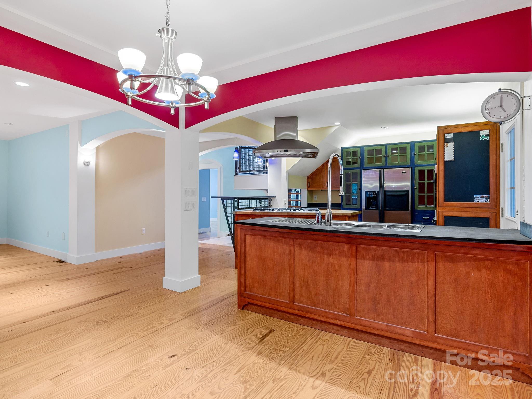 147 Woodland Road Tryon, NC 28782 - Photo 17 of 48 a large kitchen with stainless steel appliances granite countertop a red refrigerator and a stove