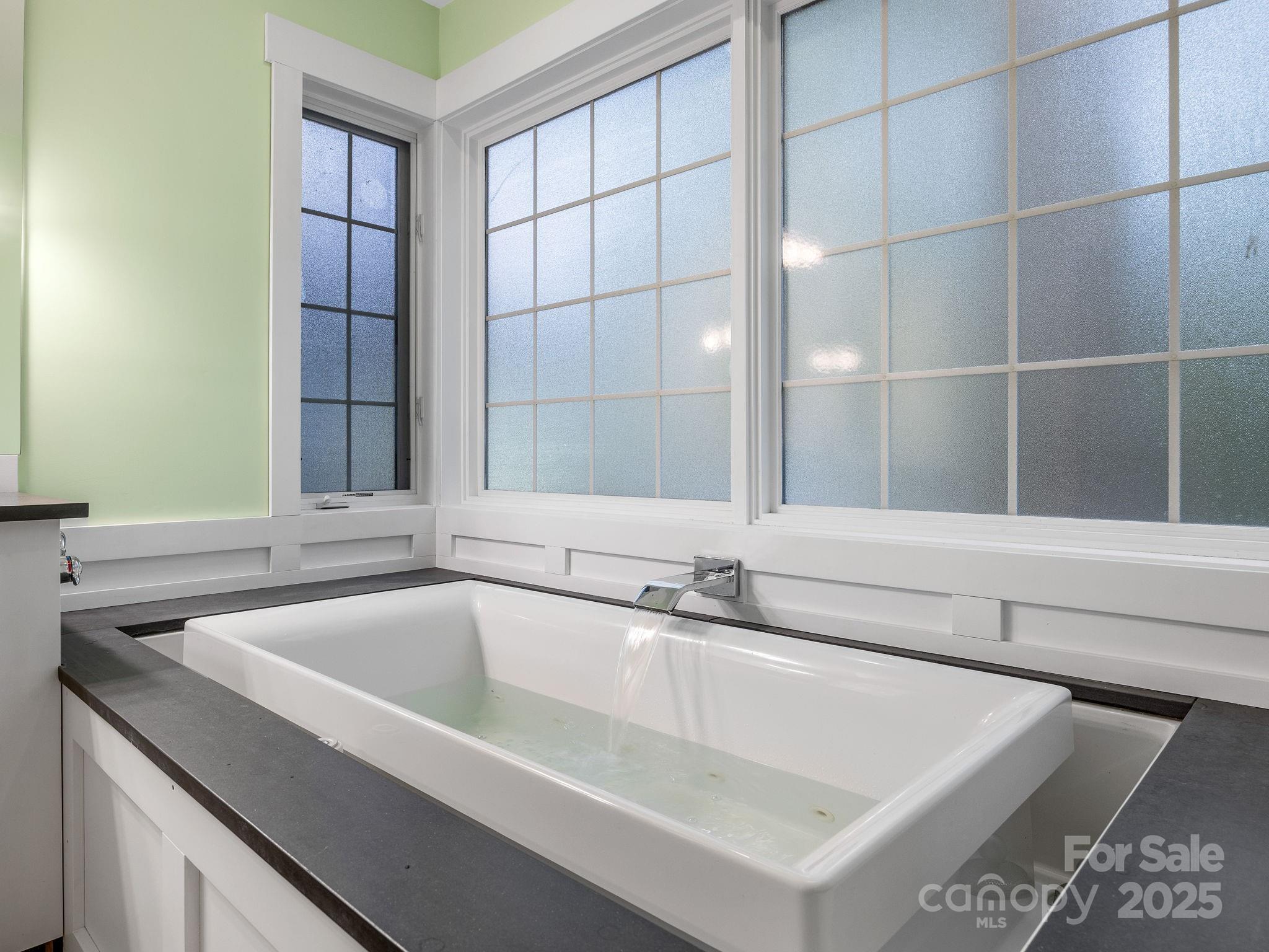 147 Woodland Road Tryon, NC 28782 - Photo 23 of 48 a bathroom with a bathtub and a sink