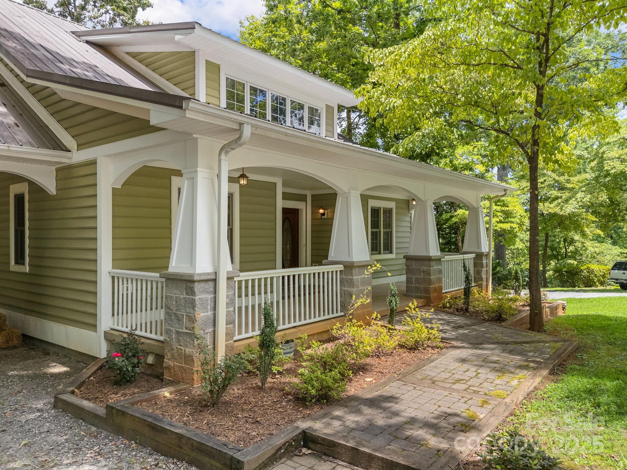 147 Woodland Road Tryon, NC 28782 - Photo 3 of 48 a front view of a house with a yard