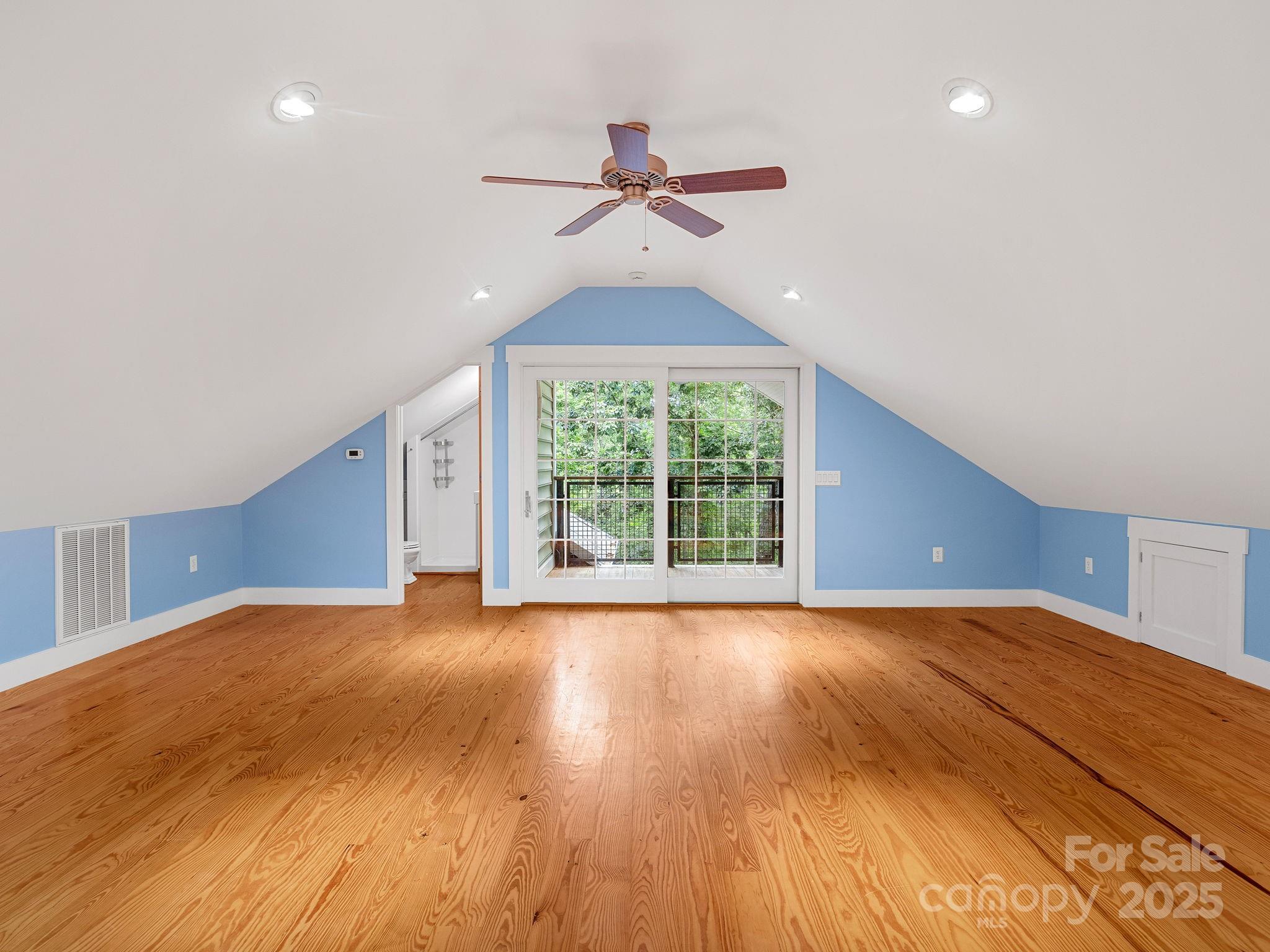 147 Woodland Road Tryon, NC 28782 - Photo 33 of 48 a view of a room with wooden floor ceiling fan and windows