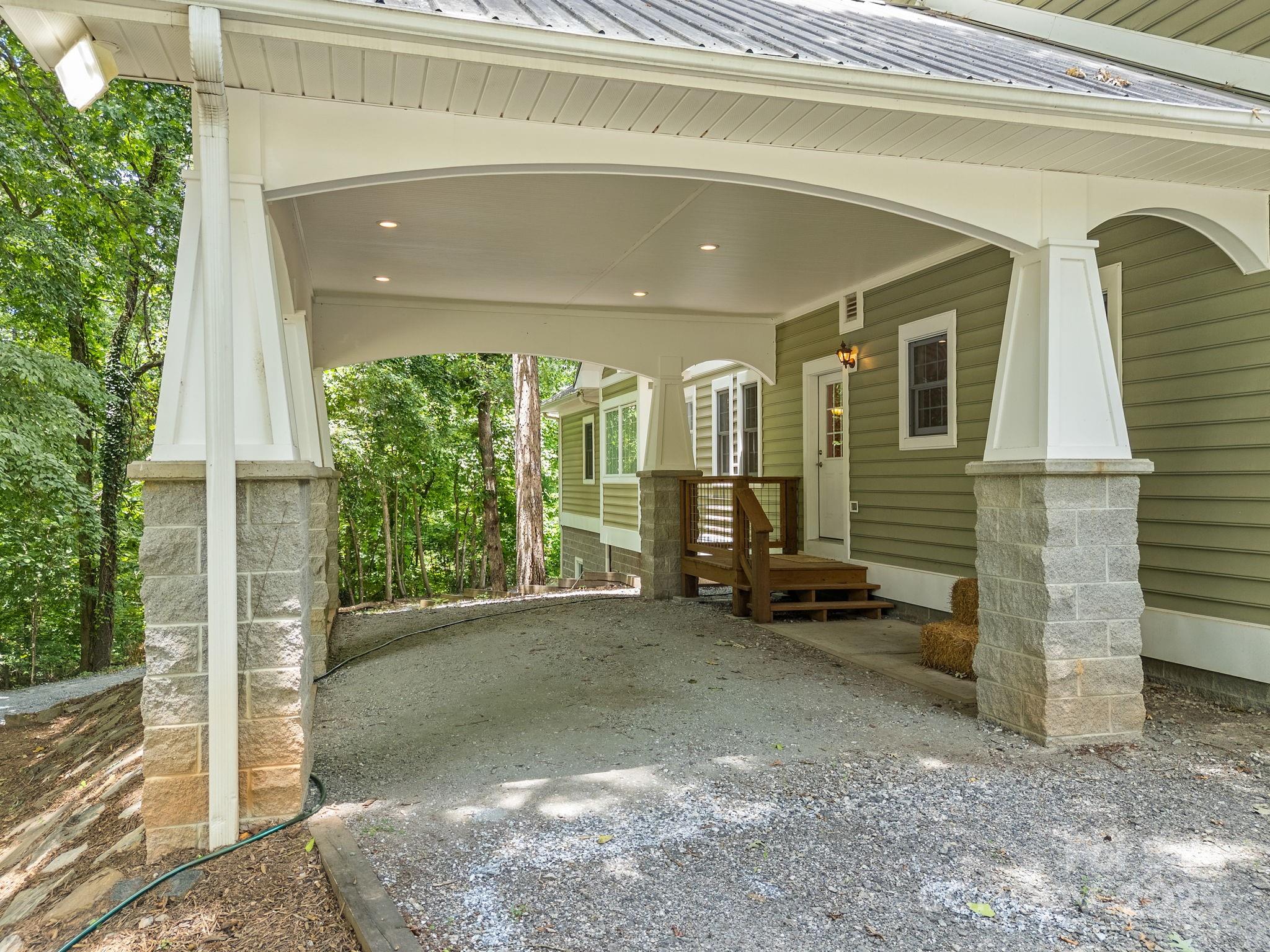 147 Woodland Road Tryon, NC 28782 - Photo 4 of 48 a view of a porch with a floor to ceiling window and potted plants