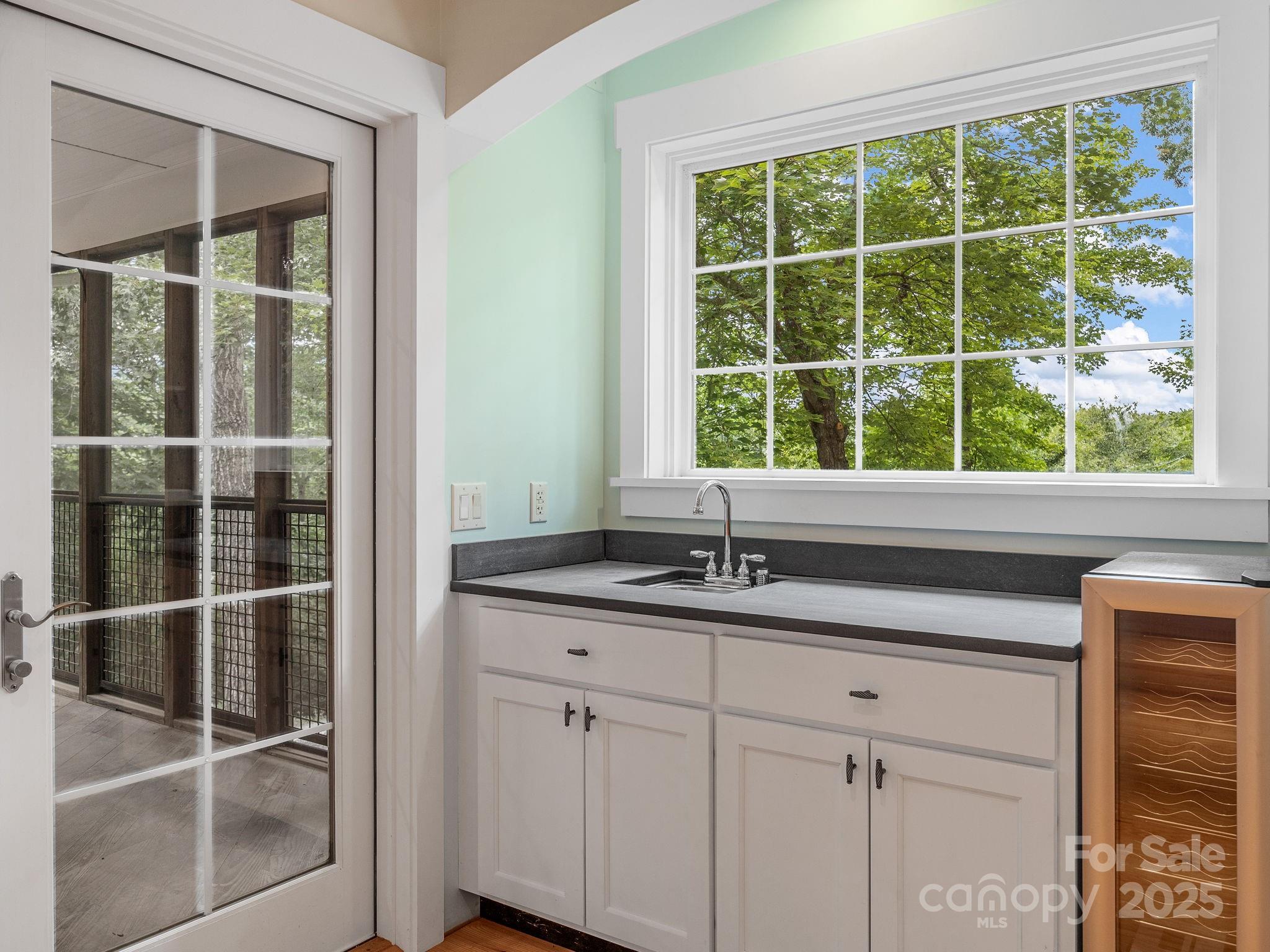 147 Woodland Road Tryon, NC 28782 - Photo 8 of 48 a kitchen with granite countertop a window and a sink