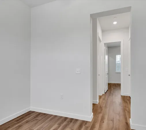 a view of a room with wooden floor