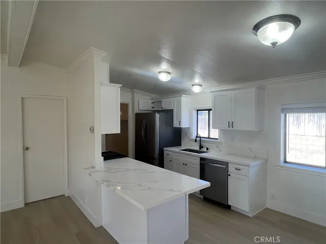 a kitchen with stainless steel appliances a sink stove and refrigerator