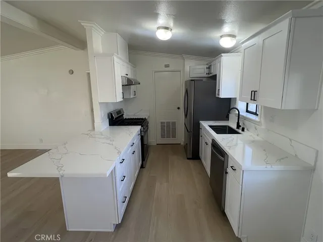 a kitchen with a sink a stove and refrigerator