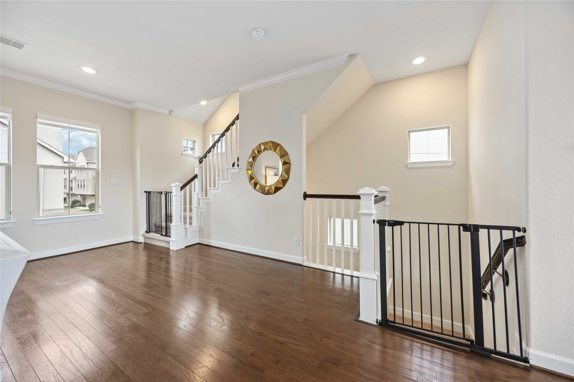 2004 Round Table Trail Houston, TX 77045 - Photo 9 of 20 A breathtaking view from the open staircase, showcasing the seamless flow of this modern home. The neutral color palette and natural light create a serene and inviting atmosphere.