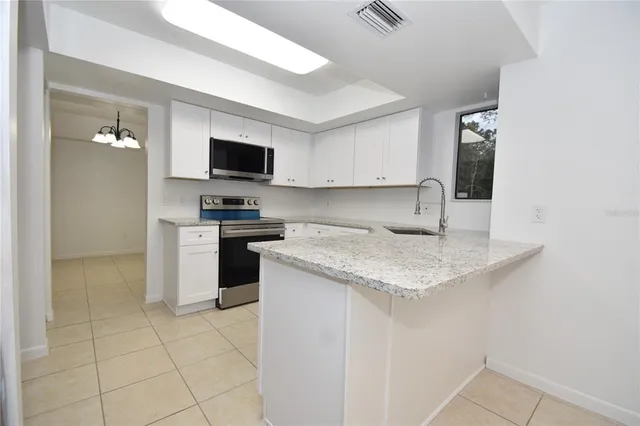 a kitchen with a stove a sink and a refrigerator