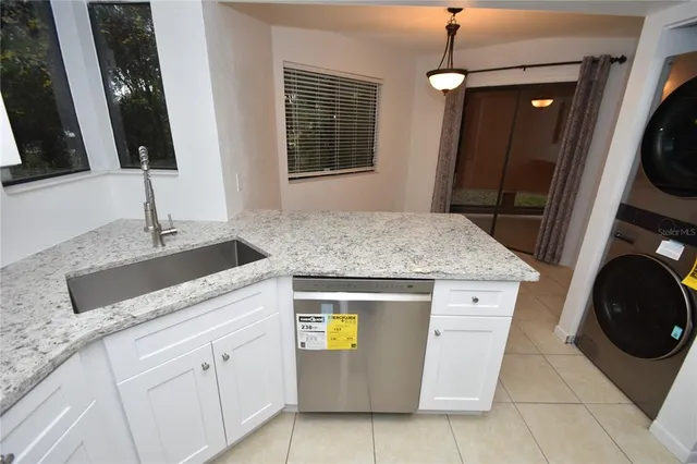 a kitchen with sink and washing machine