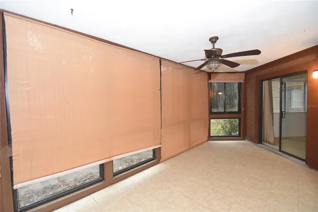 a view of a livingroom with a ceiling fan and window