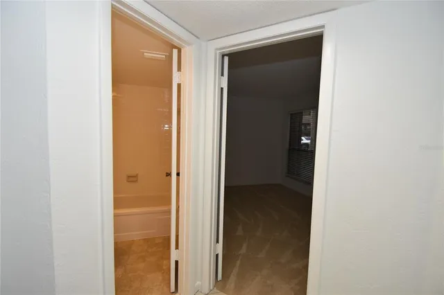 a bathroom with a granite countertop sink a toilet and bathtub