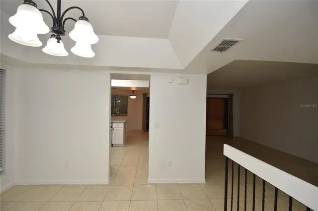 a view of a hallway with chandelier