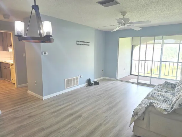 a view of a bedroom with cabinet and windows