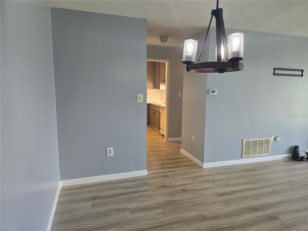 2700 Bayshore Boulevard, Unit 1302 Dunedin, FL 34698 - Photo 12 of 40 a view of empty room with wooden floor and fan