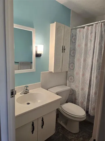 a white toilet sitting next to a bathroom sink