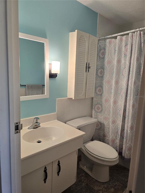 2700 Bayshore Boulevard, Unit 1302 Dunedin, FL 34698 - Photo 21 of 40 a white toilet sitting next to a bathroom sink