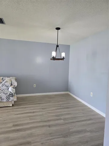 a view of room with wooden floor