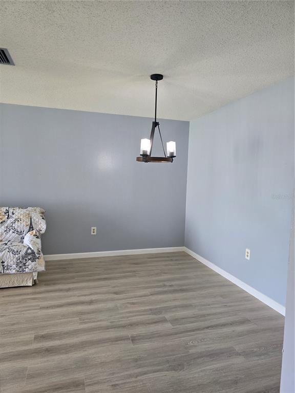 2700 Bayshore Boulevard, Unit 1302 Dunedin, FL 34698 - Photo 10 of 40 a view of room with wooden floor