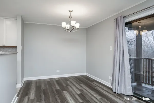 an empty room with wooden floor and door