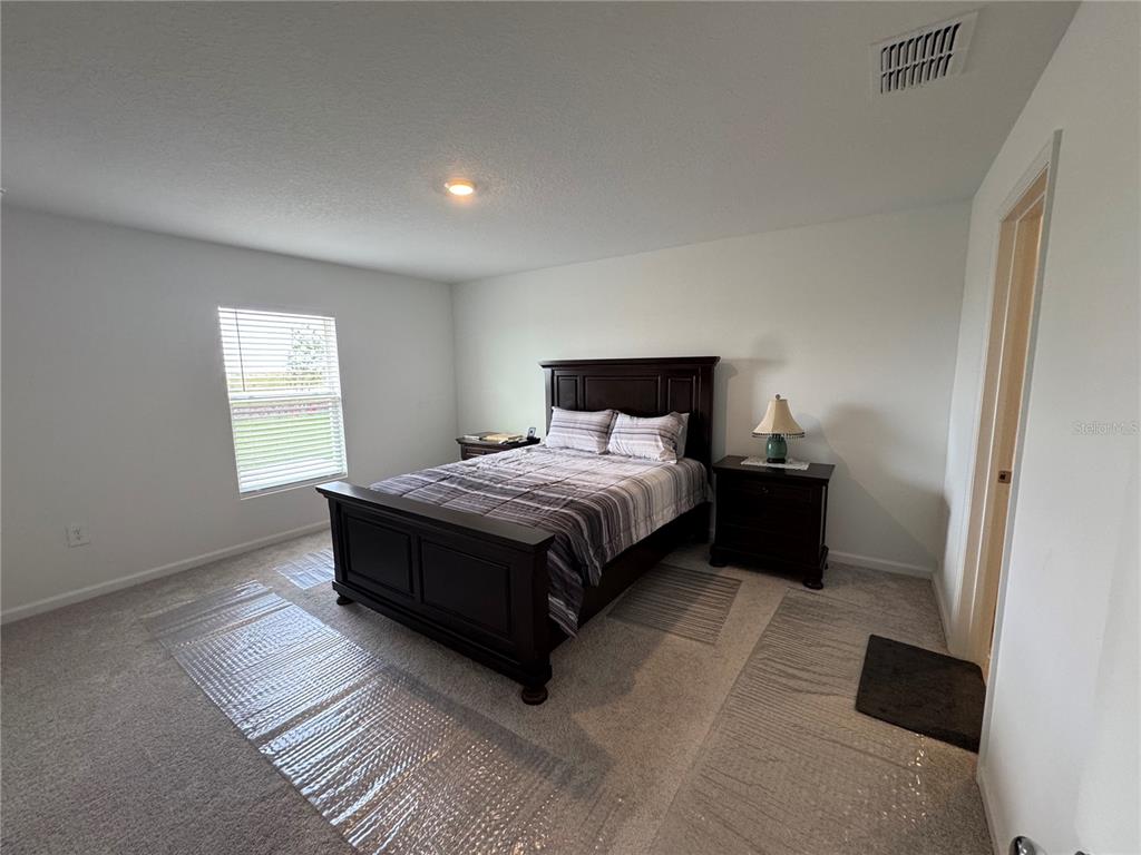 2405 Bluestone Road Haines City, FL 33844 - Photo 11 of 17 a bedroom with a bed and a window