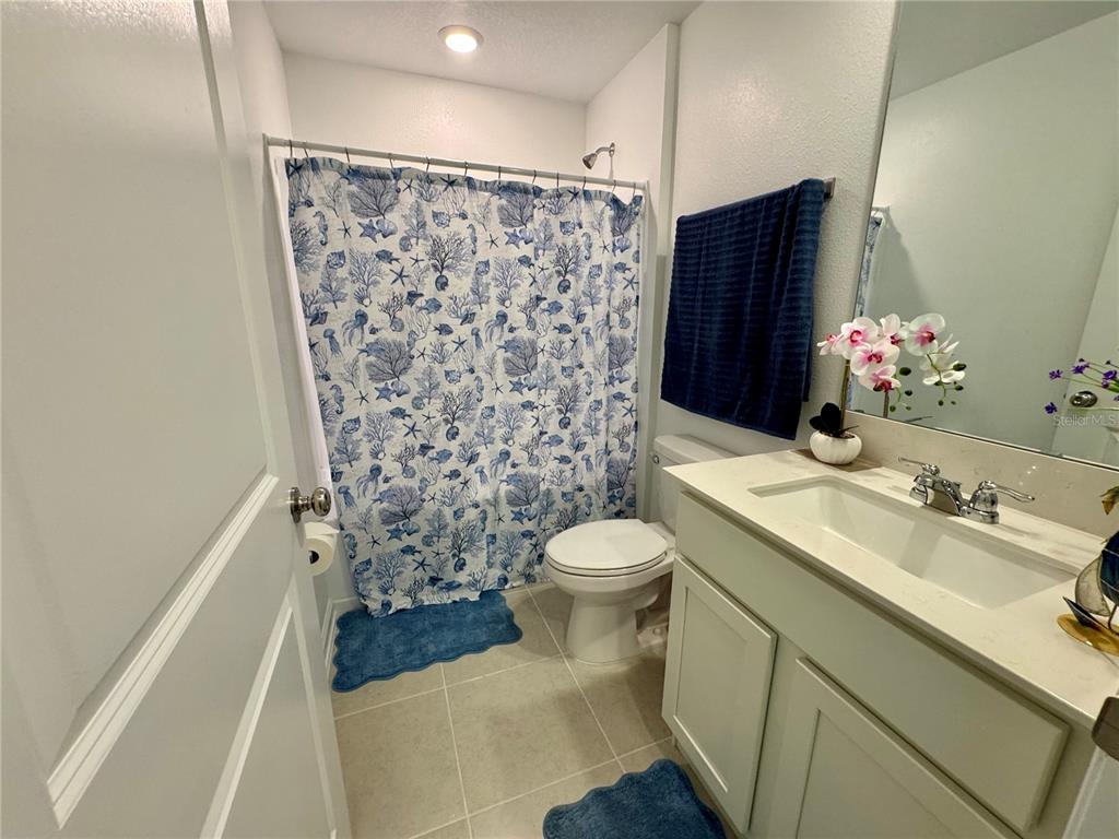 2405 Bluestone Road Haines City, FL 33844 - Photo 14 of 17 a bathroom with a sink toilet and shower