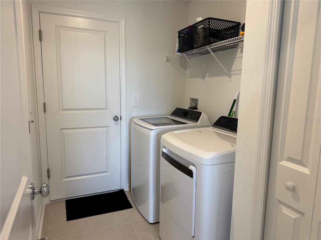 2405 Bluestone Road Haines City, FL 33844 - Photo 16 of 17 a utility room with dryer and washer