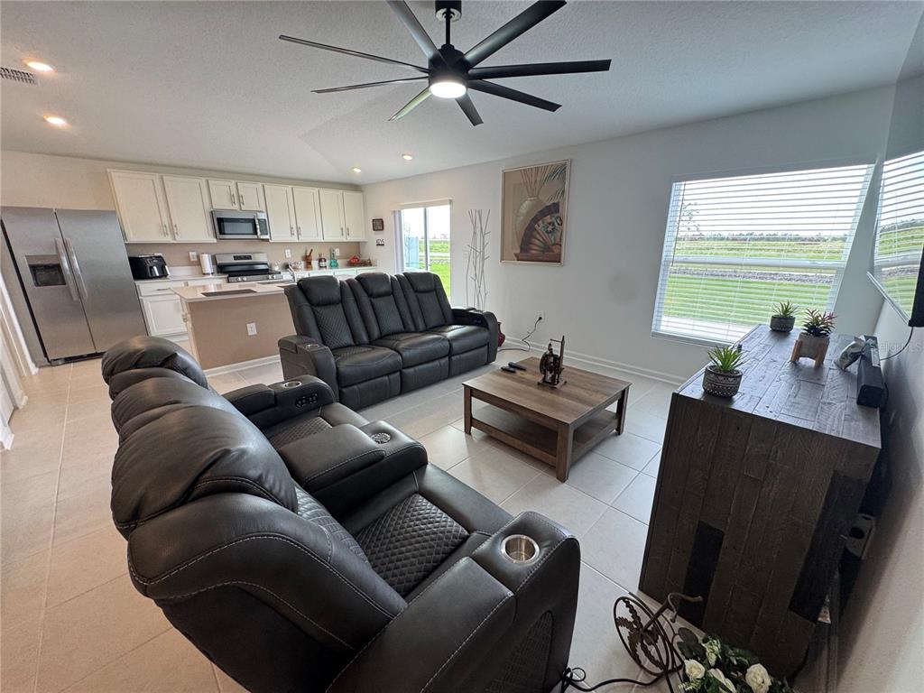 2405 Bluestone Road Haines City, FL 33844 - Photo 9 of 17 a living room with furniture a large window with kitchen view