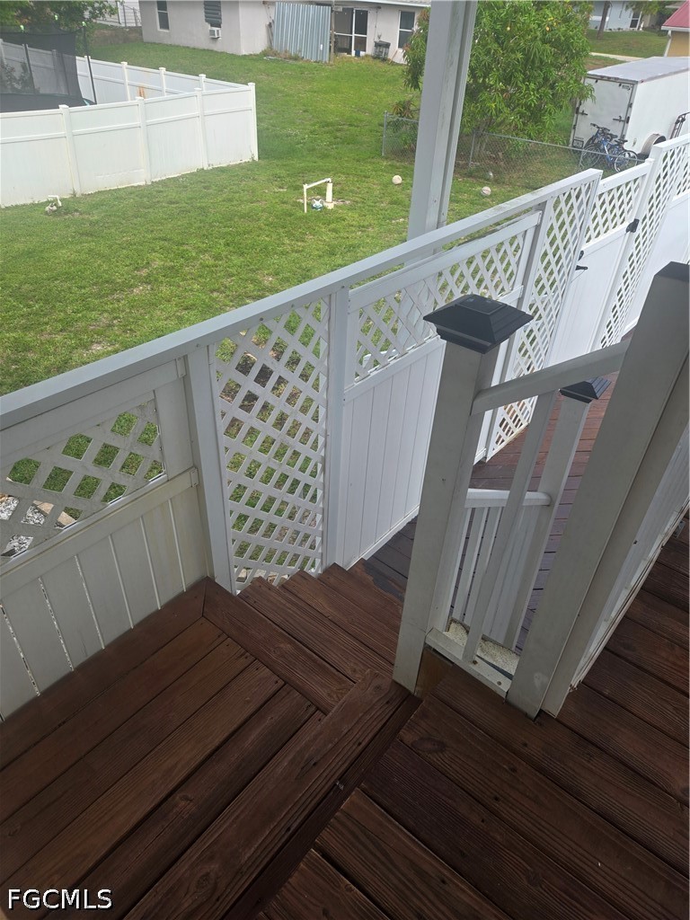 8093 Anhinga Road Fort Myers, FL 33967 - Photo 36 of 49 a view of a wooden deck with a yard