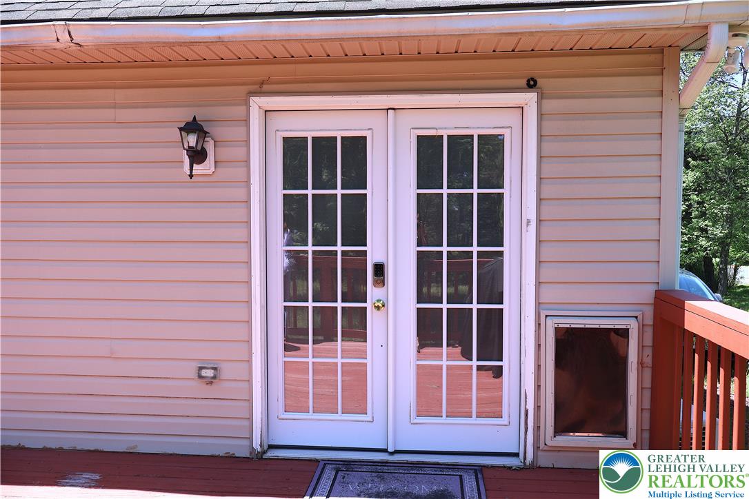 1646 Clover Road Long Pond, PA 18334 - Photo 17 of 24 Multi-pane glass doors open directly onto a spacious wooden deck with vinyl siding.