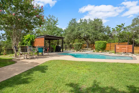 a view of a house with swimming pool and a yard
